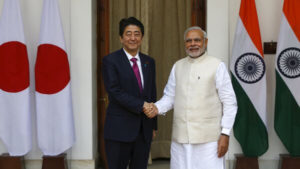 Japan's Prime Minister Shinzo Abe (L) shakes hands with his Indian counterpart Narendra Modi during a photo opportunity ahead of their meeting at Hyderabad House in New Delhi December 12, 2015 - Sputnik International