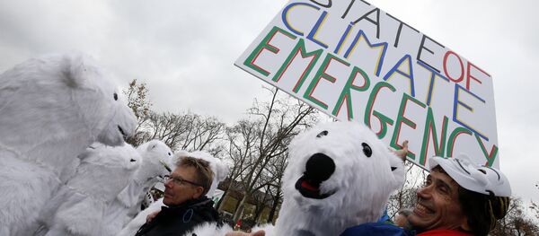 Jean-Baptiste Redde aka Voltuan holds a banner reading State of climate emergency next to demonstrators dressed-up as polar bears during a rally called by several Non Governmental Organisations (NGO) to form a human chain on the Champs de Mars near the Eiffel Tower in Paris on December 12, 2015 on the sidelines of the COP21, the UN conference on global warming. Jean-Baptiste Redde aka Voltuan holds a banner reading State of climate emergency next to demonstrators dressed-up as polar bears during a rally called by several Non Governmental Organisations (NGO) to form a human chain on the Champs de Mars near the Eiffel Tower in Paris on December 12, 2015 on the sidelines of the COP21, the UN conference on global warming. - Sputnik International