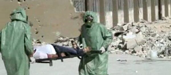 FILE - This image made from an AP video posted on Wednesday, Sept. 18, 2013 shows shows Syrians in protective suits and gas masks conducting a drill on how to treat casualties of a chemical weapons attack in Aleppo, Syria. The Islamic State group is aggressively pursuing development of chemical weapons, setting up a branch dedicated to research and experiments with the help of scientists from Iraq, Syria and elsewhere in the region, according to Iraqi and U.S. intelligence officials. (AP Photo via AP video, File) - Sputnik International