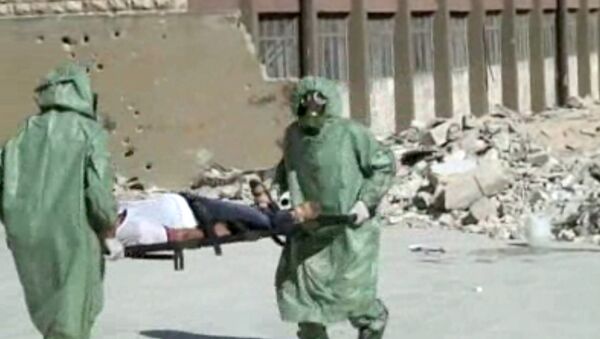 FILE - This image made from an AP video posted on Wednesday, Sept. 18, 2013 shows shows Syrians in protective suits and gas masks conducting a drill on how to treat casualties of a chemical weapons attack in Aleppo, Syria. The Islamic State group is aggressively pursuing development of chemical weapons, setting up a branch dedicated to research and experiments with the help of scientists from Iraq, Syria and elsewhere in the region, according to Iraqi and U.S. intelligence officials. (AP Photo via AP video, File) - Sputnik International