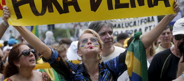 A demonstrator holds a banner which reads Out Dilma during a protest calling for the impeachment of Brazil's President Dilma Rousseff in Rio de Janeiro A demonstrator holds a banner which reads Out Dilma during a protest calling for the impeachment of Brazil's President Dilma Rousseff in Rio de Janeiro - Sputnik International