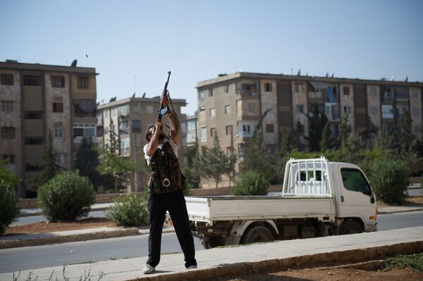 A Syrian rebel fighter fires his AK-47 rifle towards a Syrian army helicopter in Aleppo's Hanano district A Syrian rebel fighter fires his AK-47 rifle towards a Syrian army helicopter in Aleppo's Hanano district - Sputnik International