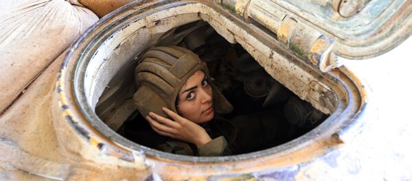 A female Syrian soldier from the Republican Guard commando battalion drives a tank during clashes with rebels in the restive Jobar area, in eastern Damascus A female Syrian soldier from the Republican Guard commando battalion drives a tank during clashes with rebels in the restive Jobar area, in eastern Damascus - Sputnik International