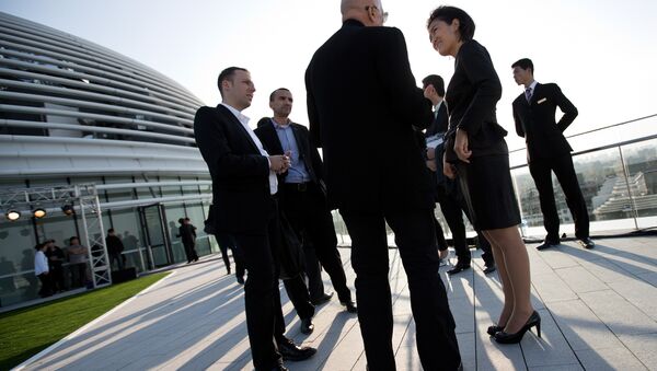Soho China CEO Zhang Xin, second from right, chats with guests at her newly opened Galaxy Soho building in Beijing Saturday, Oct. 27, 2012. - Sputnik International