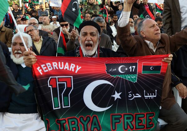 Libyan protesters shout slogans during a demonstration against a UN-sponsored agreement on forming a national unity government, on December 11, 2015 in the capital Tripoli. Libyan protesters shout slogans during a demonstration against a UN-sponsored agreement on forming a national unity government, on December 11, 2015 in the capital Tripoli. - Sputnik International