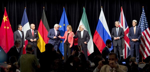 (L-R) China's Foreign Minister Wang Yi, French Foreign Minister Laurent Fabius, German Minister for Foreign Affairs Frank-Walter Steinmeier, High Representative of the European Union for Foreign Affairs and Security Policy Federica Mogherini, Iranian Foreign Minister Mohammad Javad Zarif, British Foreign Secretary Philip Hammond and US Secretary of State John Kerry pose for a picture during the final press conference of Iran nuclear talks in Vienna, Austria on July 14, 2015 (L-R) China's Foreign Minister Wang Yi, French Foreign Minister Laurent Fabius, German Minister for Foreign Affairs Frank-Walter Steinmeier, High Representative of the European Union for Foreign Affairs and Security Policy Federica Mogherini, Iranian Foreign Minister Mohammad Javad Zarif, British Foreign Secretary Philip Hammond and US Secretary of State John Kerry pose for a picture during the final press conference of Iran nuclear talks in Vienna, Austria on July 14, 2015 - Sputnik International