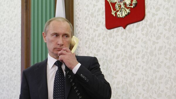 Russian President Vladimir Putin talks on the phone. File photo - Sputnik International