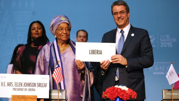 Liberian President Ellen Johnson-Sirleaf (L) holds up an identification plaque alongside World Trade Organisation (WTO) Director General Roberto Azevedo in Nairobi on December 16, 2015, during Liberia's accession to the WTO at the tenth ministerial conference - Sputnik International