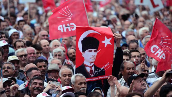 People hold a poster of Mustafa Kemal Ataturk, the founder of modern Turkey, as they listen to Turkey's main opposition Republican People's Party, CHP, leader Kemal Kilicdaroglu in Luleburgaz, Turkey, Wednesday, May 27, 2015 - Sputnik International