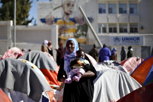 A Sudanese refugee from Darfur carries her child during an open-ended sit-in outside the United Nations High Commissioner for Refugees (UNHCR), demanding better treatment and acceleration of their relocation, in Amman, Jordan, December 6, 2015. A Sudanese refugee from Darfur carries her child during an open-ended sit-in outside the United Nations High Commissioner for Refugees (UNHCR), demanding better treatment and acceleration of their relocation, in Amman, Jordan, December 6, 2015. - Sputnik International
