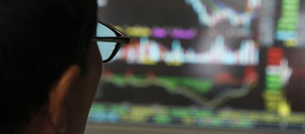 In this file photo a man examines stock update on a display at a stock brokerage in Beijing, China - Sputnik International