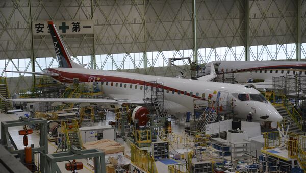 In this Friday, April 3, 2015 photo released by Mitsubishi Aircraft Corp., mechanics work on MRJ regional jet at the company's plant in Toyoyama, central Japan - Sputnik International