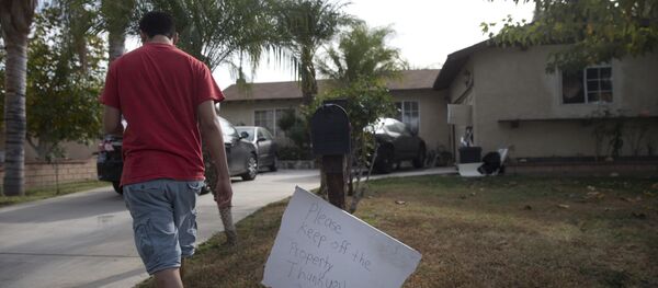 A brother of Enrique Marquez walks back to his house after collecting mail Wednesday, Dec. 9, 2015, in Riverside, Calif. A brother of Enrique Marquez walks back to his house after collecting mail Wednesday, Dec. 9, 2015, in Riverside, Calif. - Sputnik International