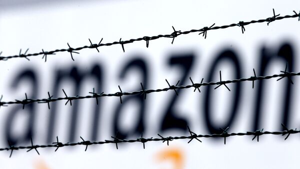 The internet trader Amazon logo is seen behind barbed wire at the company's logistic center in Rheinberg,Germany, Tuesday, Feb.19, 2013. - Sputnik International