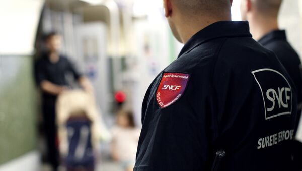 FILE -- Members of SUGE, the French police in charge of security in SNCF (French railways company) transports, patrol in Maisons-Alfort train station, south-east of Paris, as a passenger passes by, on July 5, 2012. - Sputnik International