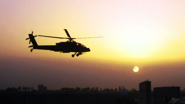 An AH-64D Apache helicopter, belonging to 1st Battalion, 4th Aviation Regiment, Attack Reconnaissance Battalion, flies over Iraq. - Sputnik International