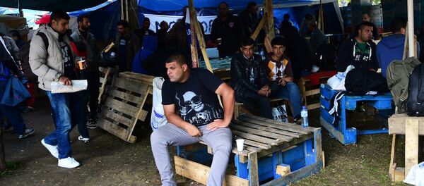 Migrants wait in a makeshift tent camp in a park in Brussels on September 9, 2015, as they wait to have their asylum claims processed Migrants wait in a makeshift tent camp in a park in Brussels on September 9, 2015, as they wait to have their asylum claims processed - Sputnik International