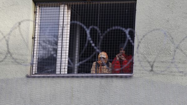 Migrants look out of a window at the Bela-Jezova refugee facility in Bela pod Bezdezem, Czech Republic, Thursday, Nov. 5, 2015 - Sputnik International