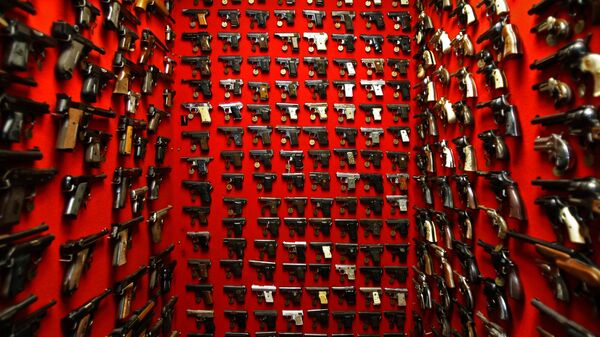 In this file photo, guns line the walls of the firearms reference collection at the Washington Metropolitan Police Department headquarters in Washington on Friday, Sept. 28, 2007 - Sputnik International