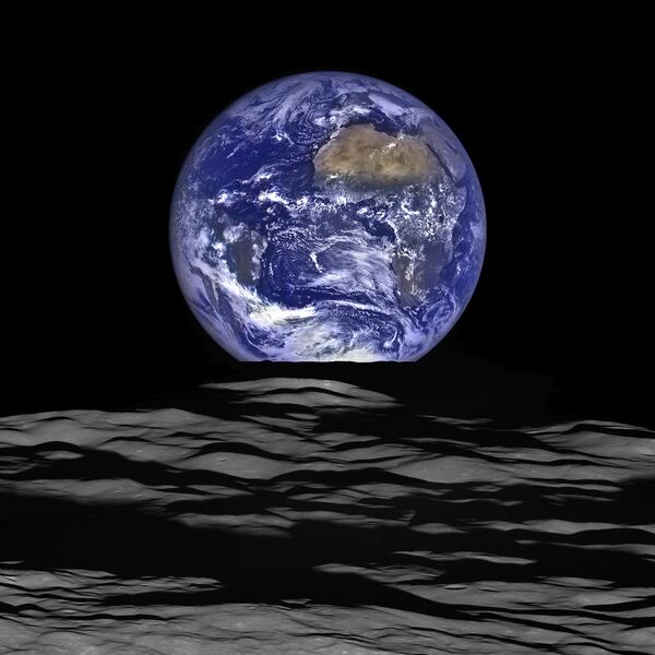 The Earth straddling the limb of the Moon, as seen from above Compton crater. Center of the Earth in this view is 4.04°N, 12.44°W, just off the coast of Liberia. The large tan area in the upper right is the Sahara desert, and just beyond is Saudia Arabia. The Atlantic and Pacific coasts of South America are visible to the left. WAC E1199291151C (Earth only), NAC M1199291564LR (Earth and Moon); sequence start time 12 October 2015 12:18:17.384 UTC The Earth straddling the limb of the Moon, as seen from above Compton crater. Center of the Earth in this view is 4.04°N, 12.44°W, just off the coast of Liberia. The large tan area in the upper right is the Sahara desert, and just beyond is Saudia Arabia. The Atlantic and Pacific coasts of South America are visible to the left. WAC E1199291151C (Earth only), NAC M1199291564LR (Earth and Moon); sequence start time 12 October 2015 12:18:17.384 UTC - Sputnik International