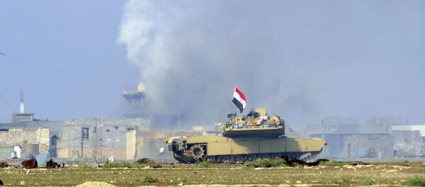 A national flag waves on an Iraqi Army Abrams tank as Iraqi forces supported by U.S.-led coalition airstrikes advance their position during clashes with Islamic State group in the western suburbs of Ramadi, the capital of Iraq's Anbar province, 70 miles (115 kilometers) west of Baghdad, Iraq, Saturday, Nov. 21, 2015 A national flag waves on an Iraqi Army Abrams tank as Iraqi forces supported by U.S.-led coalition airstrikes advance their position during clashes with Islamic State group in the western suburbs of Ramadi, the capital of Iraq's Anbar province, 70 miles (115 kilometers) west of Baghdad, Iraq, Saturday, Nov. 21, 2015 - Sputnik International