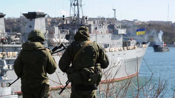 Russian forces patrol near the Ukrainian navy ship Slavutich in the harbor of the Ukrainian city of Sevastopol on March 5, 2014 - Sputnik International