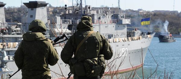 Russian forces patrol near the Ukrainian navy ship Slavutich in the harbor of the Ukrainian city of Sevastopol on March 5, 2014 Russian forces patrol near the Ukrainian navy ship Slavutich in the harbor of the Ukrainian city of Sevastopol on March 5, 2014 - Sputnik International