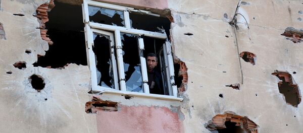A man looks out of a building which was damaged during the security operations and clashes between Turkish security forces and Kurdish militants, in Sur district of Diyarbakir, Turkey A man looks out of a building which was damaged during the security operations and clashes between Turkish security forces and Kurdish militants, in Sur district of Diyarbakir, Turkey - Sputnik International
