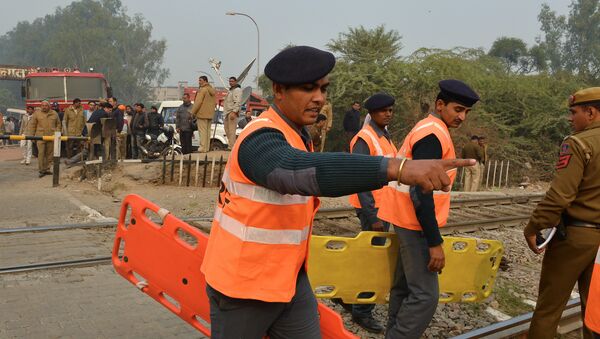 Members of the National Disaster Response Force (NDRF) direct operations near the crash site of a chartered army plane close to the main airport in New Delhi on December 22, 2015 - Sputnik International