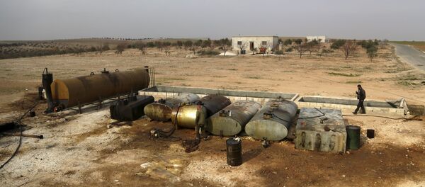 Men work at a makeshift oil refinery site in Marchmarin town, southern countryside of Idlib, Syria December 16, 2015. The refinery site, owned by Yousef Ayoub, 34, has been active for 4 months. Ayoub says that he gets the crude oil from Islamic State-controlled areas in Deir al-Zor province and Iraq. The price for a barrel of crude oil varies and is controlled by the Islamic State, but it is currently at $44 dollars per barrel, he said. Men work at a makeshift oil refinery site in Marchmarin town, southern countryside of Idlib, Syria December 16, 2015. The refinery site, owned by Yousef Ayoub, 34, has been active for 4 months. Ayoub says that he gets the crude oil from Islamic State-controlled areas in Deir al-Zor province and Iraq. The price for a barrel of crude oil varies and is controlled by the Islamic State, but it is currently at $44 dollars per barrel, he said. - Sputnik International
