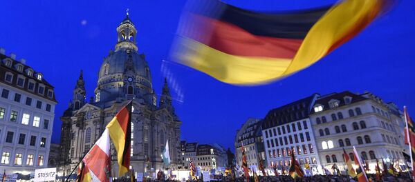 Protestors wave a German flag in front of the Church of Our Lady during a demonstration of PEGIDA (Patriotic Europeans against the Islamization of the West) in Dresden, eastern Germany Protestors wave a German flag in front of the Church of Our Lady during a demonstration of PEGIDA (Patriotic Europeans against the Islamization of the West) in Dresden, eastern Germany - Sputnik International