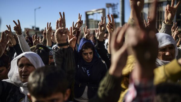 Members of the Kurdish community flash the V for victiry sign during a demonstration in Sirnak - Sputnik International