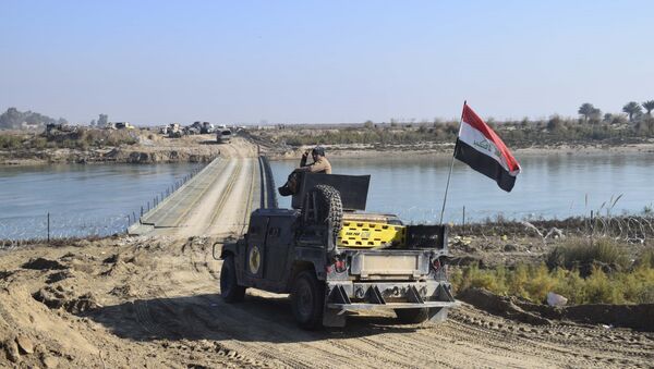 Iraqi security forces cross a bridge built by corps of Engineers over the Euphrates River as Islamic State destroyed all the bridges leading to central Ramadi to block Iraqi security forces from moving forward in Ramadi, 70 miles (115 kilometers) west of Baghdad, Iraq, Tuesday, Dec. 22, 2015 - Sputnik International