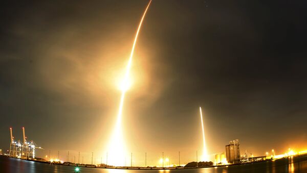 A long exposure photograph shows the SpaceX Falcon 9 lifting off (L) from its launch pad and then returning to a landing zone (R) at the Cape Canaveral Air Force Station, on the launcher's first mission since a June failure, in Cape Canaveral, Florida - Sputnik International