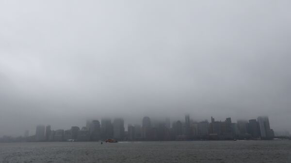 A boat chugs along the Hudson River as fog and clouds blanket over the New York City Skyline seen from Liberty State Park, Wednesday, Dec. 23, 2015, in Jersey City, N.J - Sputnik International