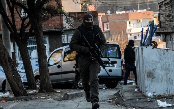 Turkish masked plain clothes police officer patrols a street during a clash between Kurdish activists and Turkish police in the historical Sur district on December 24,2015 in Diyarbakir - Sputnik International