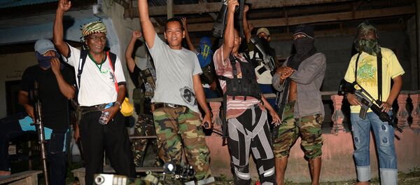 Abu Misry Mama (front L), spokesman of the Bangsamoro Islamic Freedom Fighters (BIFF) a splinter group of the Moro Islamic Liberation Front (MILF) that still wants independence, along with colleagues shout Allah Akbar (God is Great) after an interview with selected members of the media in Maguindanao, in southern island of Mindanao on March 28, 2014 Abu Misry Mama (front L), spokesman of the Bangsamoro Islamic Freedom Fighters (BIFF) a splinter group of the Moro Islamic Liberation Front (MILF) that still wants independence, along with colleagues shout Allah Akbar (God is Great) after an interview with selected members of the media in Maguindanao, in southern island of Mindanao on March 28, 2014 - Sputnik International