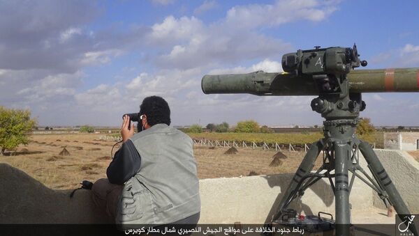 In this file photo released on Dec. 21, 2015, by the Rased News Network on a page affiliated with Islamic State militants, an Islamic State militant prepares to fire a TOW-1 anti-tank missile in Aleppo, northern Syria - Sputnik International