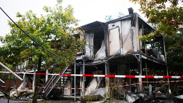 Burned out mobile homes are seen at a refugee shelter on October 18, 2015 in Hamburg, northern Germany (File) - Sputnik International