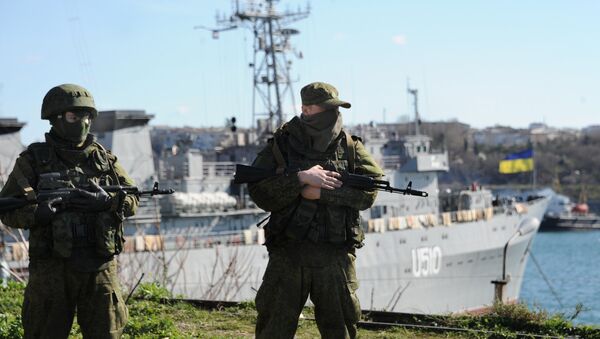 Russian forces look out at the Ukrainian navy ship Slavutich in the harbor of the Ukrainian city of Sevastopol on March 5, 2014 - Sputnik International