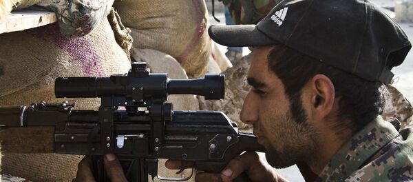 FILE - In this Wednesday, Nov. 19, 2014 file photo, Kurdish People's Protection Units (YPG) fighters take position at a stronghold in Kobani, Syria. Drawing on thousands of fighters from Syria's mix of religious and ethnic groups, a U.S.-backed alliance called the Syrian Democratic Forces has emerged as the most effective fighting force against the Islamic State group in Syria. - Sputnik International