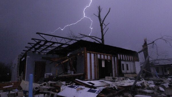 Lightning illuminates a house after a tornado touched down in Jefferson County, Ala., damaging several houses, Friday, Dec. 25, 2015, in Birmingham, Ala. A Christmastime wave of severe weather continued Friday. - Sputnik International