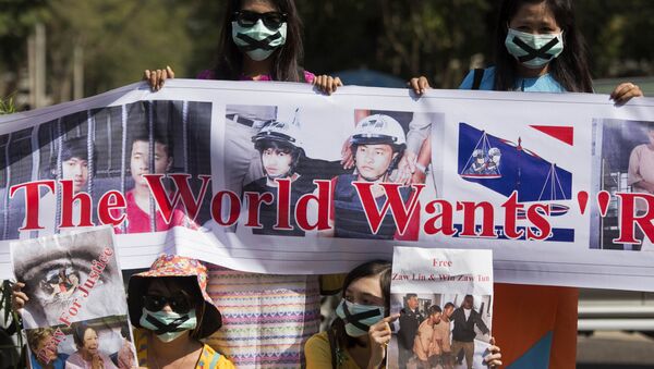 Demonstrators hold placards outside the Thai embassy in Yangon on December 26, 2015 to protest against the death sentence of Myanmar labour workers Zaw Lin and Win Zaw Tun for the murder of two British backpackers on the Thai island of Koh Tao - Sputnik International