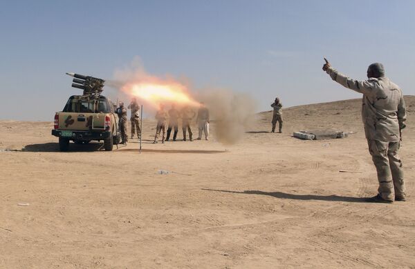 Iraqi security forces and allied Popular Mobilization Forces fire rockets at Daesh positions at an oil field outside Beiji, some 250 kilometers (155 miles) north of Baghdad, Iraq, Saturday, Oct. 24, 2015 Iraqi security forces and allied Popular Mobilization Forces fire rockets at Daesh positions at an oil field outside Beiji, some 250 kilometers (155 miles) north of Baghdad, Iraq, Saturday, Oct. 24, 2015 - Sputnik International