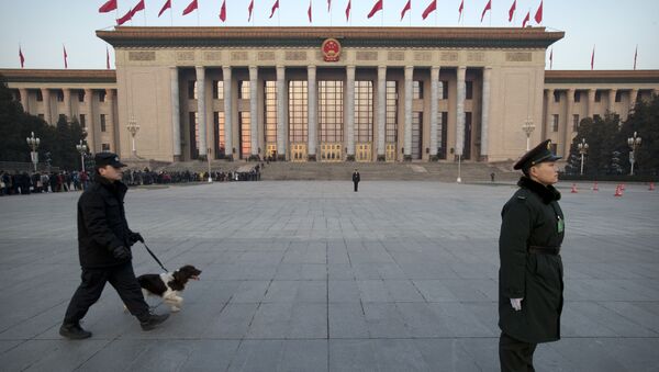 A Chinese paramilitary policeman, right, stands guard in front of the Great Hall of the People as a security officer walks past with a search dog before the opening session of the annual National People's Congress in Beijing, Thursday, March 5, 2015 - Sputnik International