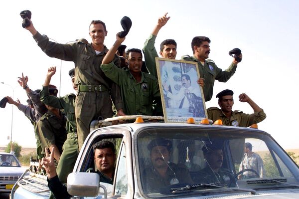 Iraqi soldiers celebrate 15 October 2002 on their way to vote in the presidential referendum in the city of Tikrit, Saddam Hussein's birthplace, some 170 kms north of the capital Baghdad Iraqi soldiers celebrate 15 October 2002 on their way to vote in the presidential referendum in the city of Tikrit, Saddam Hussein's birthplace, some 170 kms north of the capital Baghdad - Sputnik International