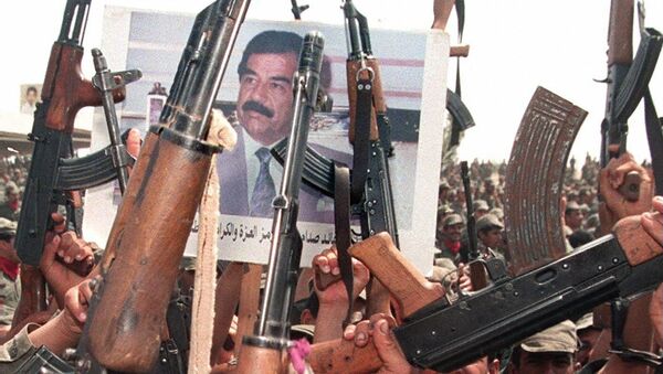Iraqi soldiers hold up their arms during celebrations to mark the 61st birthday of Iraqi President Saddam Hussein 28 April 1998, in his home town of Tikrit, north of Baghdad - Sputnik International