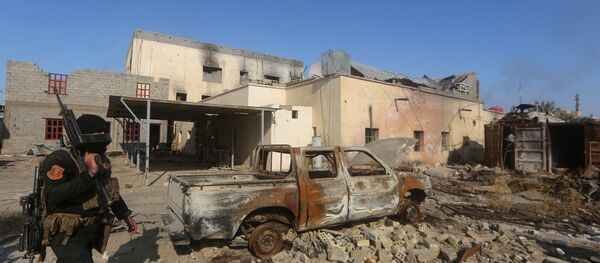 A member of Iraq's elite counter-terrorism service walks with his weapon on December 28, 2015 in the city of Ramadi, the capital of Iraq's Anbar province, about 110 kilometers west of Baghdad, after Iraqi forces recaptured it from the Islamic State (IS) jihadist group. A member of Iraq's elite counter-terrorism service walks with his weapon on December 28, 2015 in the city of Ramadi, the capital of Iraq's Anbar province, about 110 kilometers west of Baghdad, after Iraqi forces recaptured it from the Islamic State (IS) jihadist group. - Sputnik International