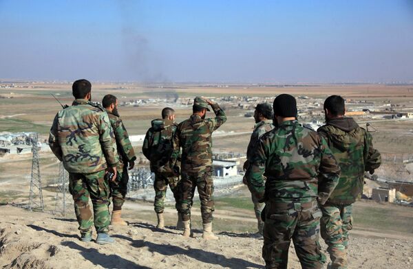 Syrian pro-government fighters look at smoke rising on the horizon following government air strikes on the Tal Sharba area, on the outskirts of the northern Syrian city of Aleppo, after they seized the area from Islamic State (IS) group jihadists on December 27, 2015 Syrian pro-government fighters look at smoke rising on the horizon following government air strikes on the Tal Sharba area, on the outskirts of the northern Syrian city of Aleppo, after they seized the area from Islamic State (IS) group jihadists on December 27, 2015 - Sputnik International