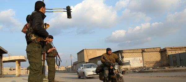 Members of the Kurdish internal security forces (known as the Asayish) check vehicles on December 16, 2015 in the northeastern Syrian city of Qamishli Members of the Kurdish internal security forces (known as the Asayish) check vehicles on December 16, 2015 in the northeastern Syrian city of Qamishli - Sputnik International